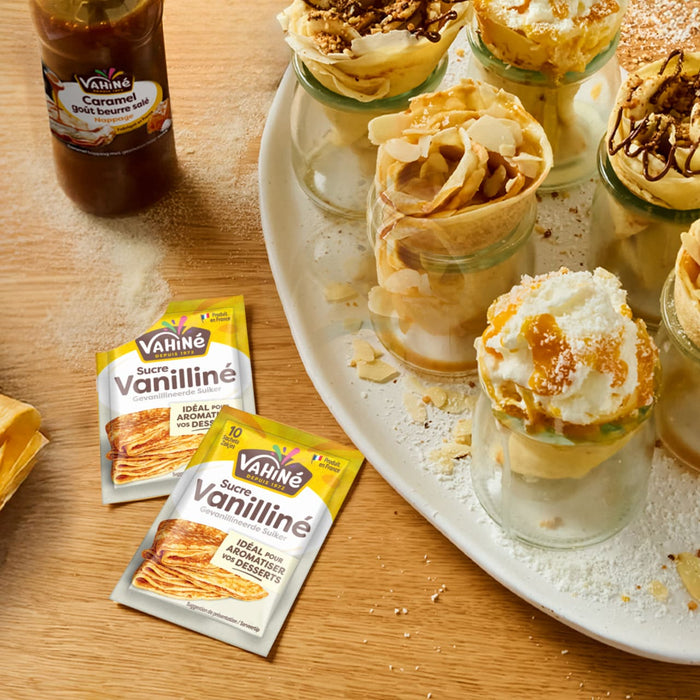 Un plateau de desserts prACsentant des sachets de sucre vanillAC Kania Vanillino et des coupes de crAapes garnies de diverses faA?ons.