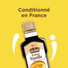 Une bouteille d'extrait de vanille VahinAC, portant la mention ConditionnAC en France, est prACsentACe sur un fond jaune.