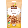 Un paquet de Vahiné Pralin présentant un tas de morceaux de pralin avec des noisettes et des amandes.