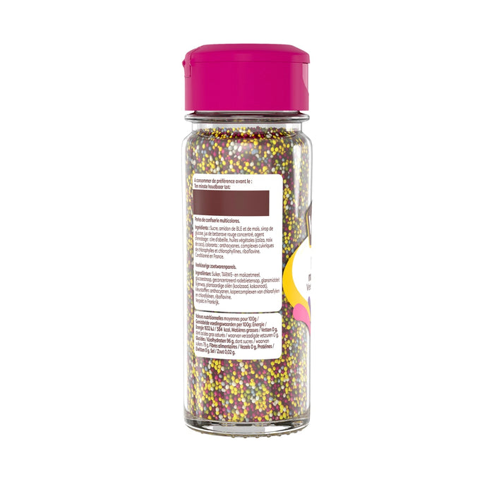 Une bouteille de vermicelles colorACs avec un couvercle rose, probablement utilisACe pour dACcorer des desserts.