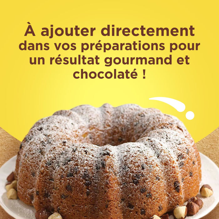 Un délicieux gâteau aux pépites de chocolat saupoudré de sucre glace, suggérant que le produit peut être ajouté directement aux préparations pour un résultat gourmand et chocolaté.