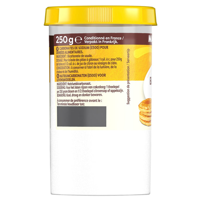 Un pot blanc de Carbonates de Sodium (E500) Vahine, aussi connus sous le nom de bicarbonate de soude, présente un couvercle jaune et une étiquette avec des instructions et une suggestion de présentation de pancakes.