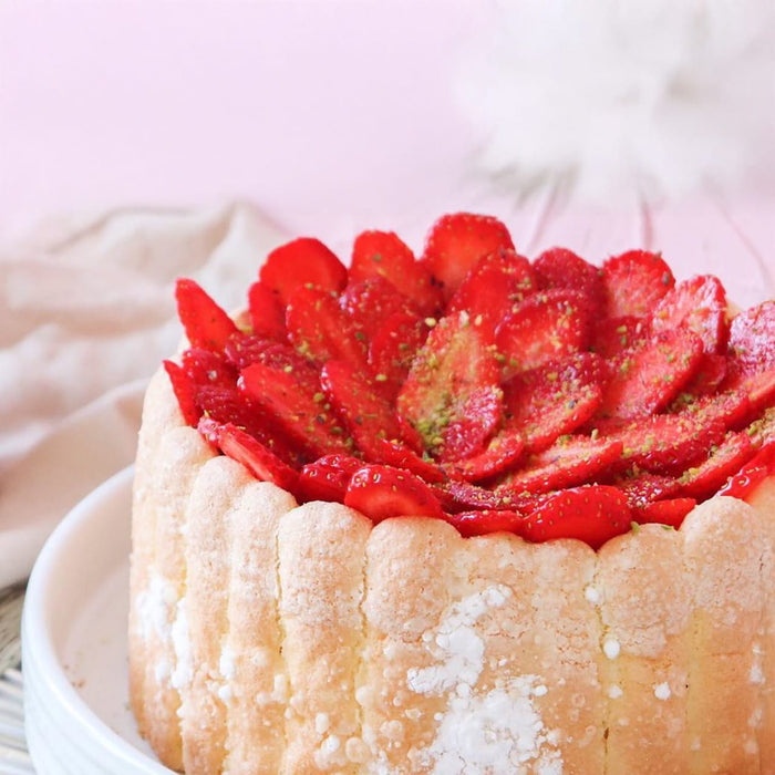 Un dAClicieux gActeau Charlotte aux fraises est prACsentAC, mettant en valeur son extACrieur en biscuits A? la cuillA?re et sa garniture de fraises fraARches.