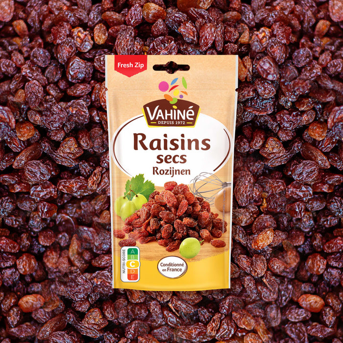 Un paquet de Raisins secs Vahiné est présenté sur un fond de raisins secs en vrac.