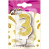 Une bougie d'anniversaire de la marque Valrhona en forme de chiffre trois, recouverte de paillettes dorées.