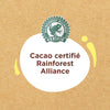 Un badge informatif pour Vahine Sch Pepites Chocolaitx10-Va, affichant un ovale blanc avec le texte Cacao certifié Rainforest Alliance et le logo vert de la grenouille Rainforest Alliance Vérifié sur un fond texturé marron.