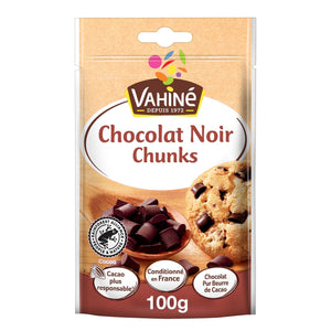 Un emballage Vahiné de Vahine Sch100G Pepites Chunkx10-Va, présentant des pépites de chocolat noir dans une cuillère en bois et un cookie aux pépites de chocolat, avec le produit clairement étiqueté Chocolat Noir Chunks Spécial Cookies 100g.